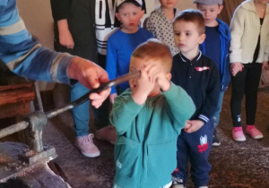 Chłopiec bierze udział w procesie robienia oleju