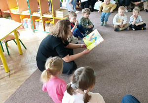 Nauczyciel czyta wiersz Jana Brzechwy "Siedmiomilowe buty"